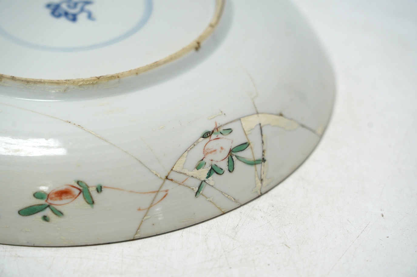 A Chinese powder blue famille verte dish, Kangxi period, a Yongzheng Imari plate and a Kangxi blue and white saucer, largest 22cm diameter. Condition - poor